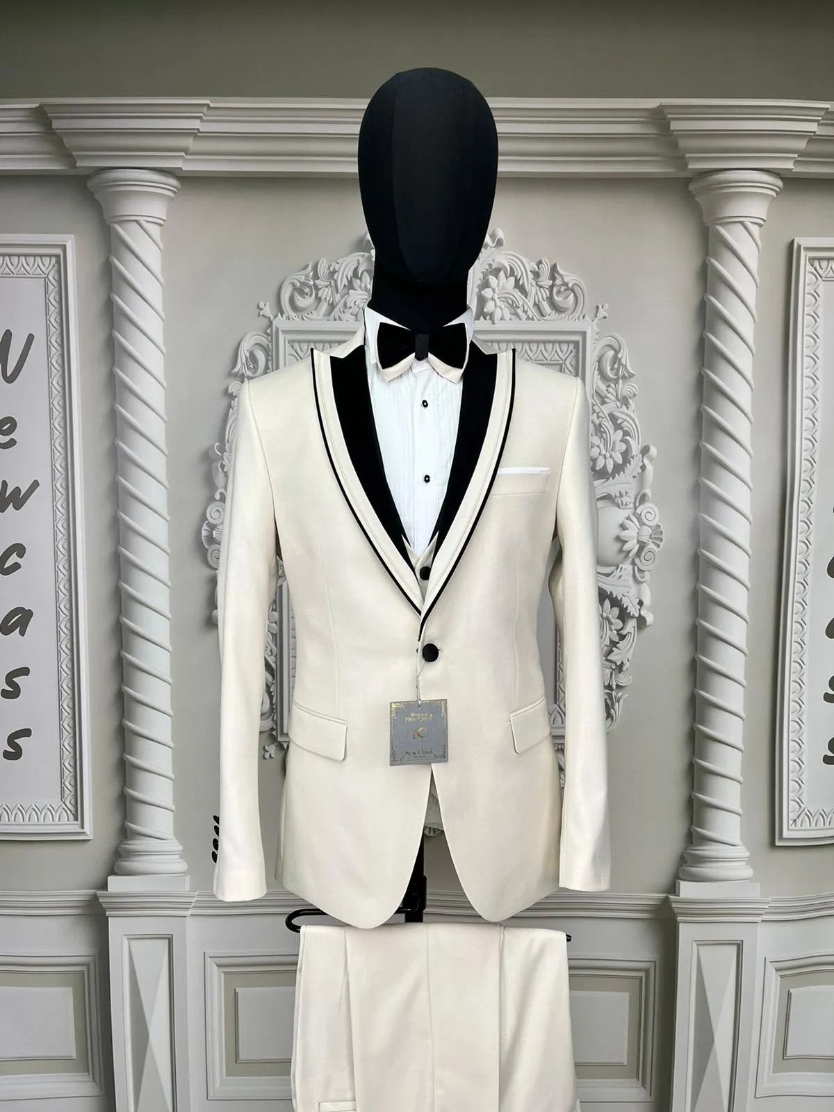 Single Button Three Pieces Tuxedo Suit with contrasting green velvet Lapel, matching bow tie and Black Pants.